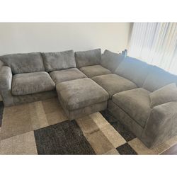 Gray sectional sofa with ottoman