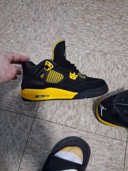 Black and yellow Jordan 4s
