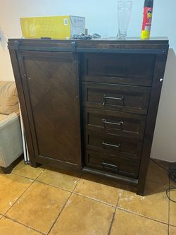 Dark wood sliding barn door with shelves and drawers