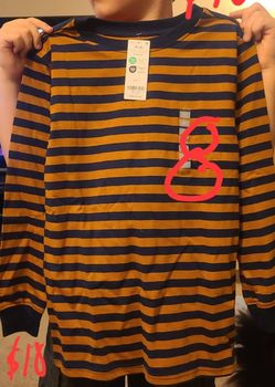 Brand new with tags Kids Carter's long sleeved orange and navy blue striped shirt size 8.