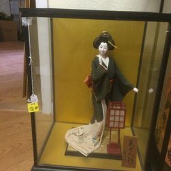 Geisha lady in glass box