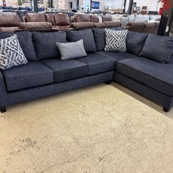 Two piece navy sectional with pillows