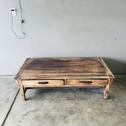 Solid wooden coffee table with two drawers.