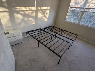 Two black twin metal bed frames