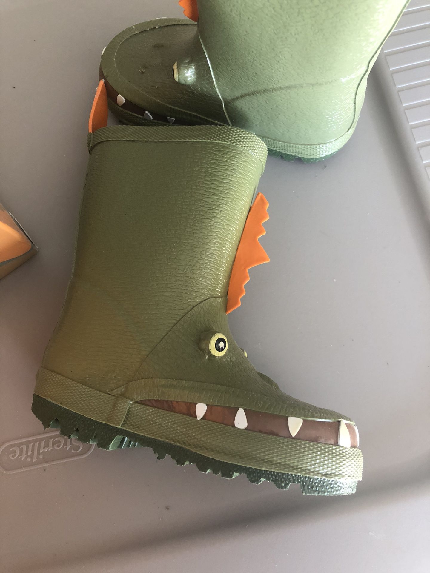 Child’s first step rain boots Dino size 5.