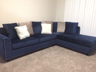 Brand new velvet upholstered sectional with nail head trim.