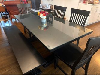 Beautiful black wood kitchen table with four chairs and a bench