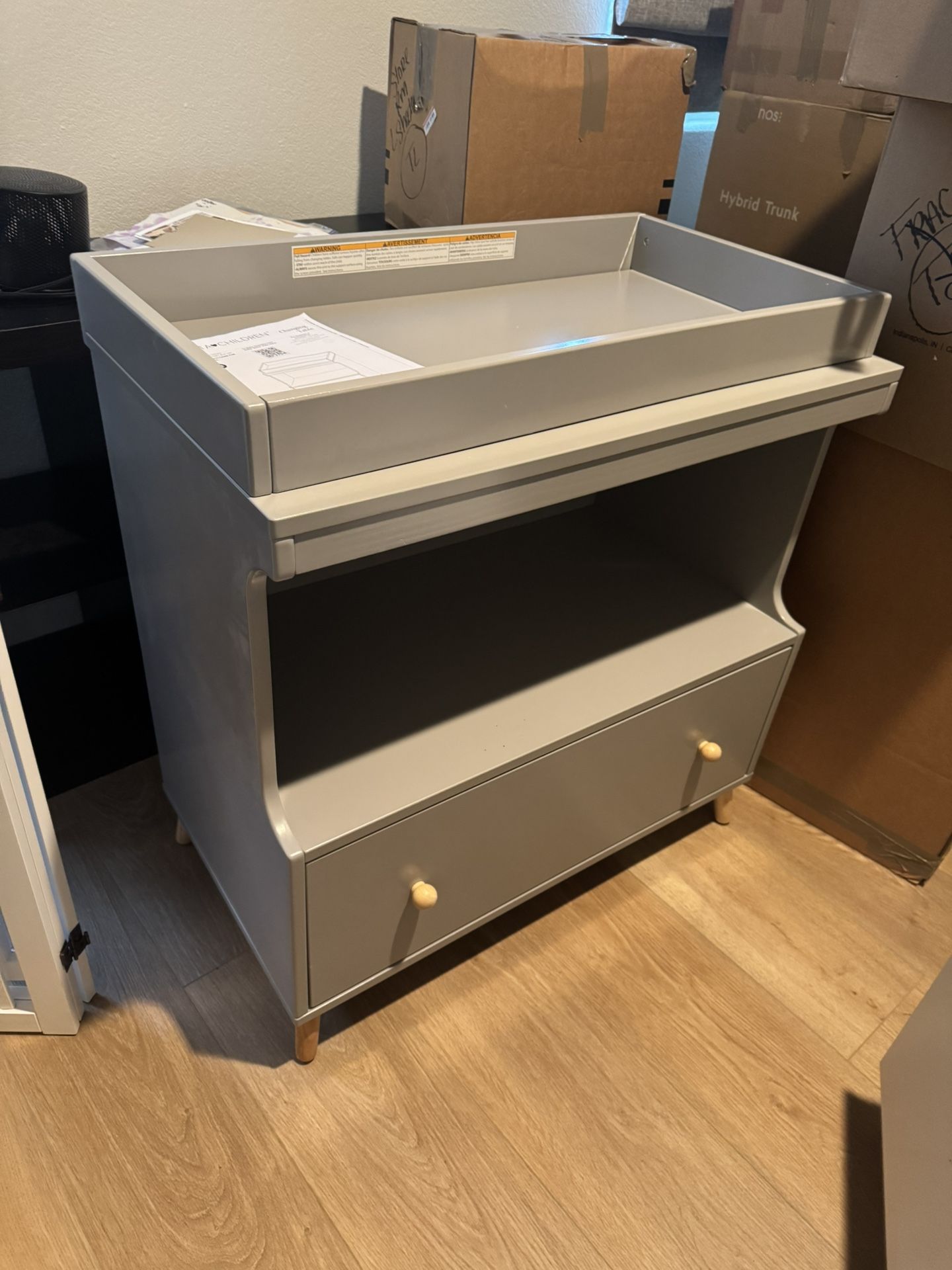 Delta convertible changing table with drawers