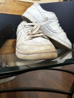 Nike Dunk Low sneakers in an all-white colorway, size 10.