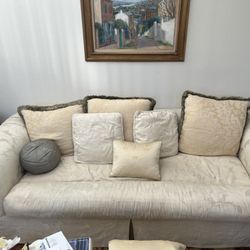 ivory couch sofa furniture seating with pillows 