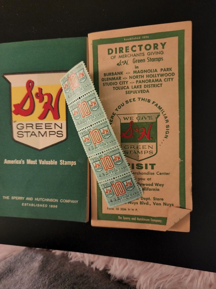 S&H GREEN STAMP BOOK AND BOOKLET OF THE DIRECTORY OF MERCHANTS GIVING GREEN STAMPS AND WHERE TO TURN IN YOUR STAMPS FOR MERCHANDISE CENTERS.