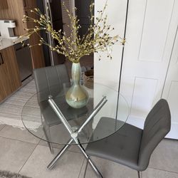 $100 Round Glass Table W/ 2 Gray Faux Leather Chairs