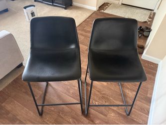 2 black leather barstools