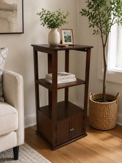 Sturdy  wooden shelf unit with two shelves and a cabinet .