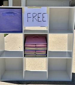 White cubbies with bins