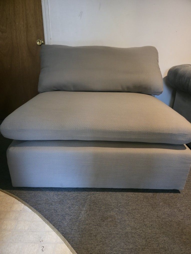 Raleigh armless armchair upholstered in grey bouclé