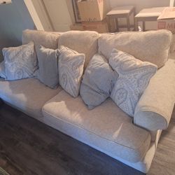 Beige Couch With 5 Pillows