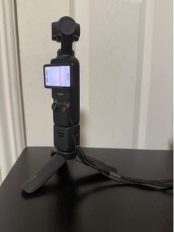dji osmo pocket 3 with battery handle and mini tripod