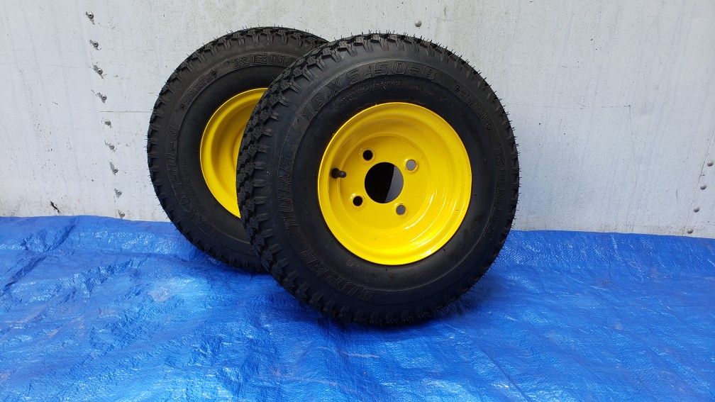 Pair of 18x6.50-8 Kenda Superturf tires on a 4-lug JD yellow wheel