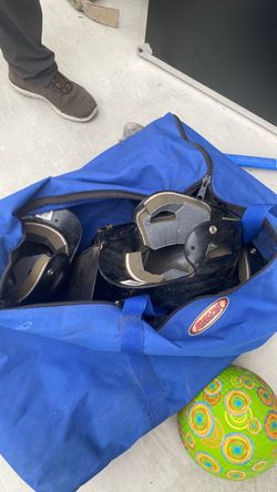 Catcher helmet and shin guards with mitt and five helmets in Blue Bag