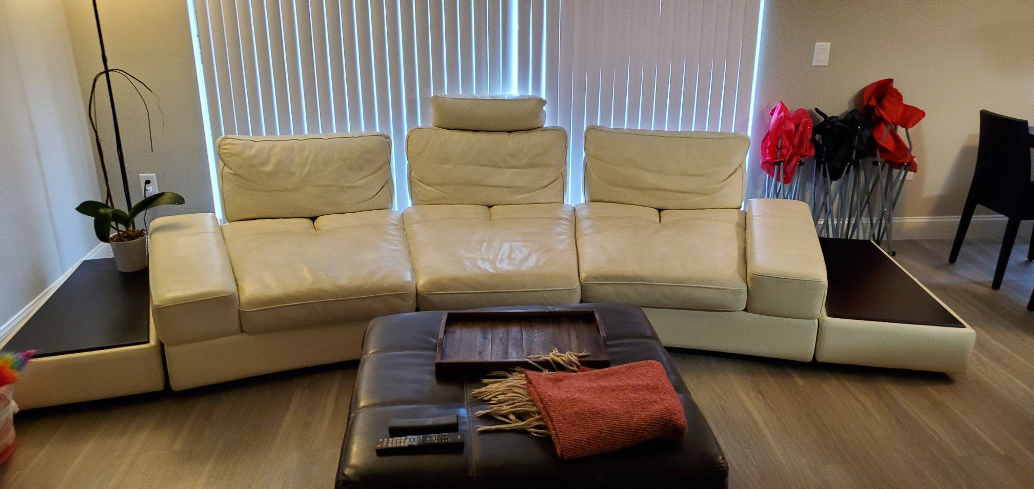 White leather sectional couch with table ends