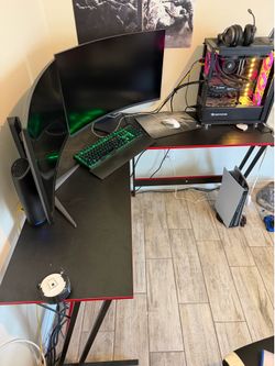 L shaped desk and racing sim seat