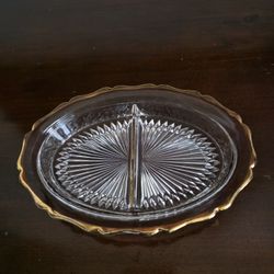 Glass divided serving dish with gold-trimmed scalloped edge and starburst pattern by Jeanette Glass Company