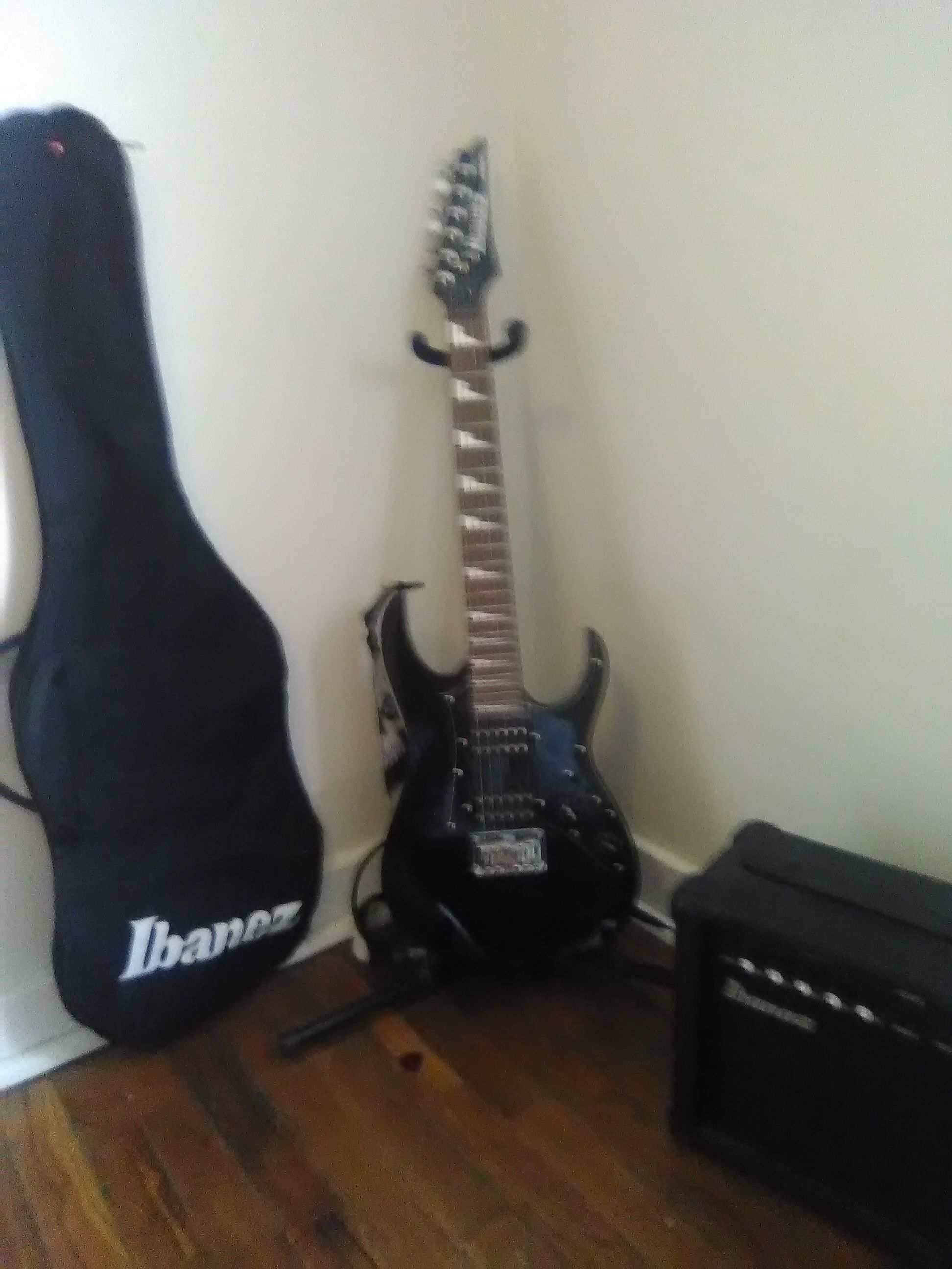 Black and White Ibanez micro electric guitar. With amp wire and bag.