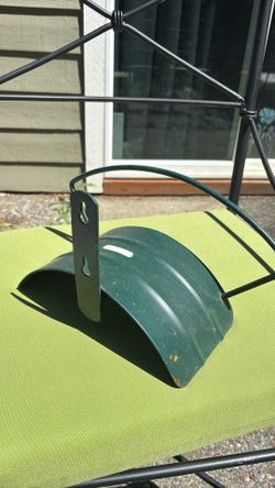 Green garden hose wall mount