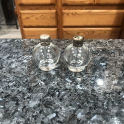 Vintage round Glass Salt and Pepper Shakers Metal Cap. Size 2 inches tall. Preowned good condition.