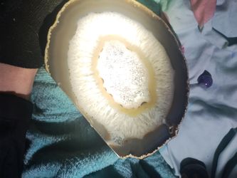 This is a polished agate geode slice containing Quartz