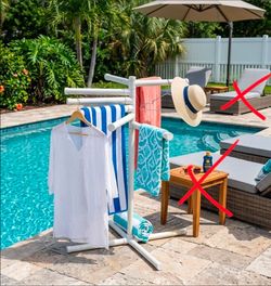 handmade, portable PVC pipe towel holder designed with multiple swivel-style hanging arms and a four-way base.