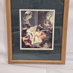 A print titled "Cherubs Angels" and is framed and matted. 