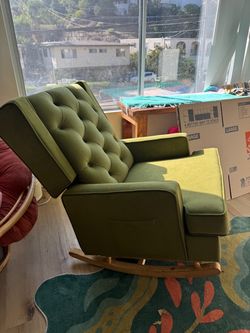 Green upholstered rocking chair with side pocket