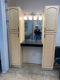 Hair stylist station with cabinets and shampoo bowl
