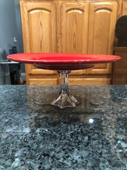Vintage Red Round cake plate on a clear pedestal.  The plate had a star design.  Size 10 1/ 2 inches wide and 5 inches tall.  Preowned very good condi