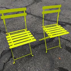 2 GREEN METALLIC FOLDING CHAIRS
