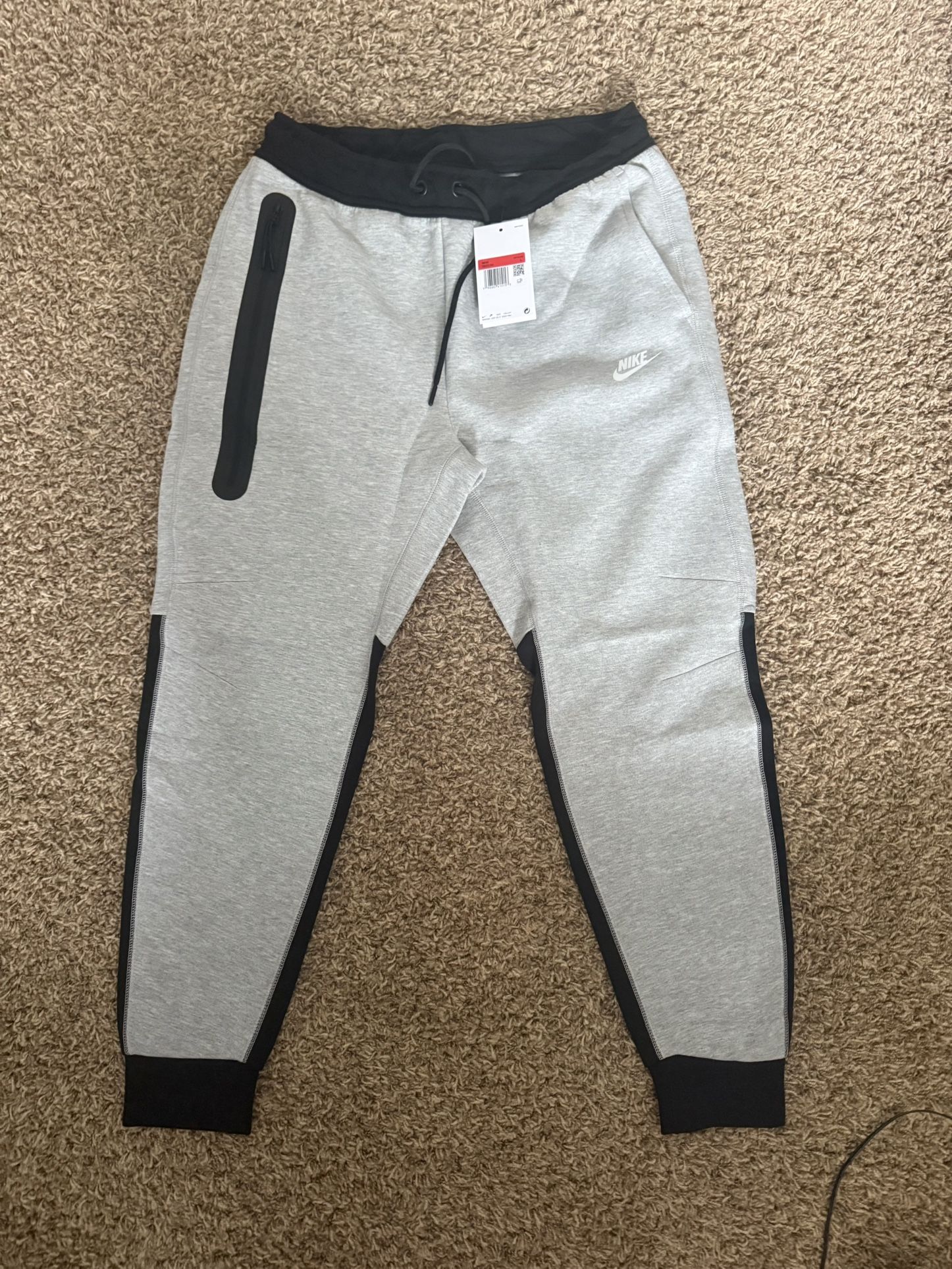 grey and black Nike tech fleece joggers