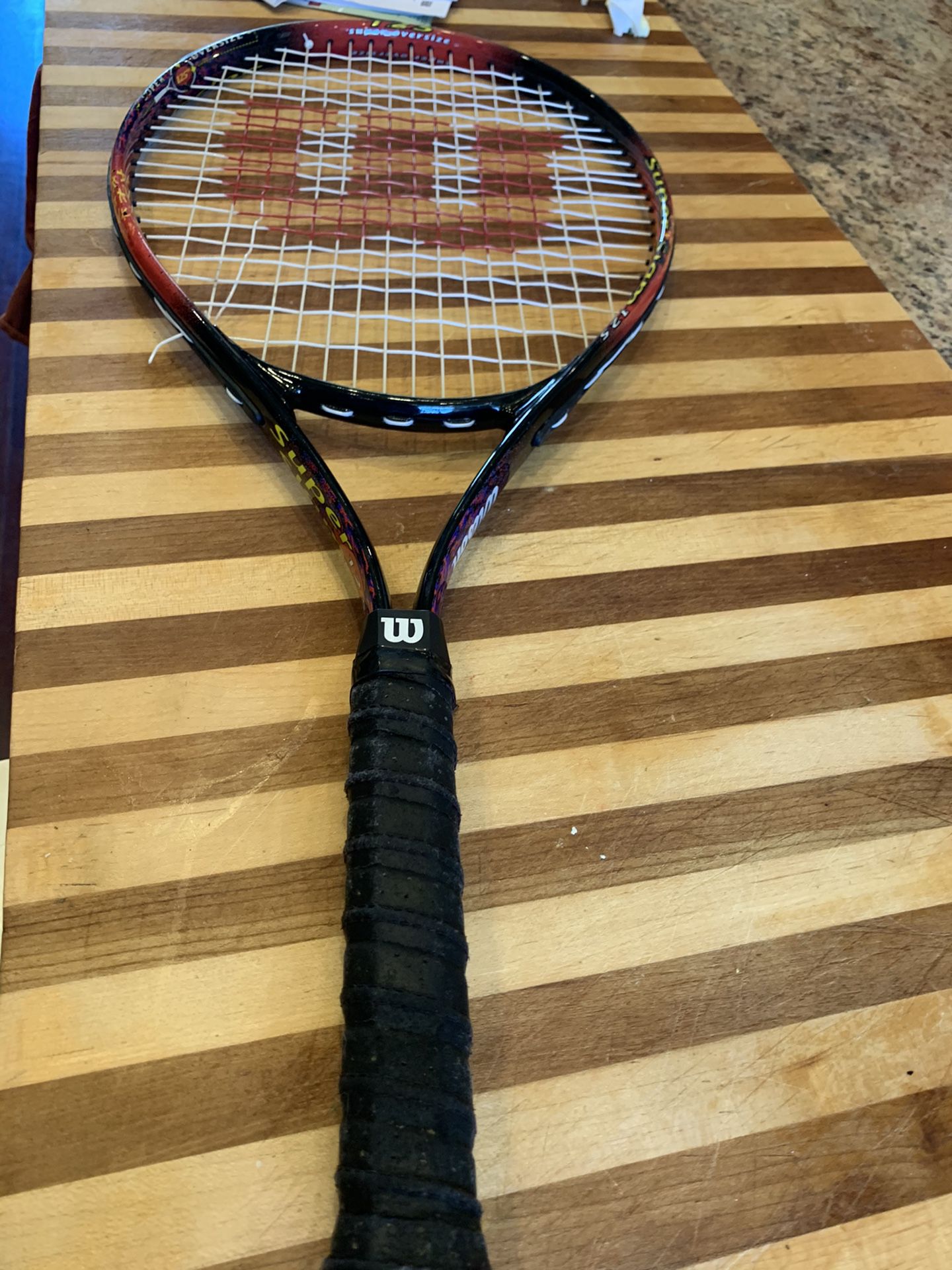 Three tennis rackets with two bags
