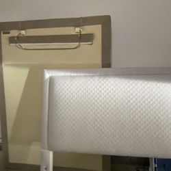 Adjustable Queen bed frame with massage feature, mattress, and headboard.