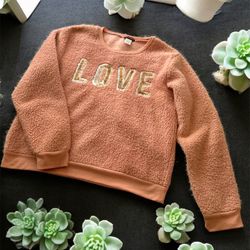 Soft pink fleece sweater with 'LOVE' lettering