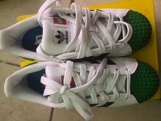 Adidas Lego x Superstar sneakers in a white and green colorway