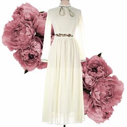 Ivory long sleeved maxi dress with embellished waist and matching broach