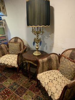 Two sofa chairs and coffee table and large lamp the chairs the fabric need to be change