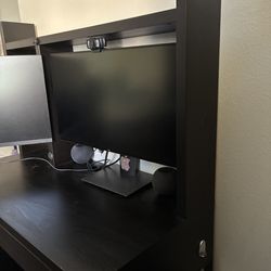 IKEA desk with a monitor in a stand included.