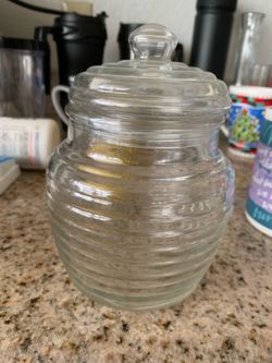 A vintage Anchor Hocking beehive-shaped clear glass jar