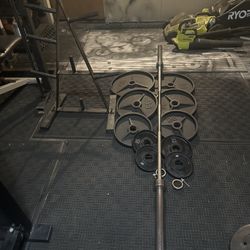240lbs of Olympic weights with 7ft bar with clamps plus weights tree