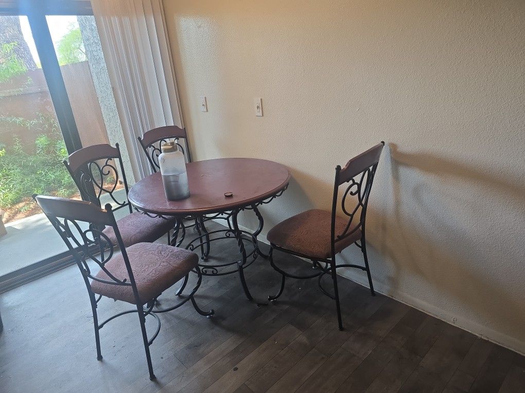 Wooden And Steel Chairs And Round Dinner Table