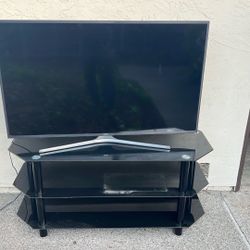 55 inches Samsung TV and black TV stand