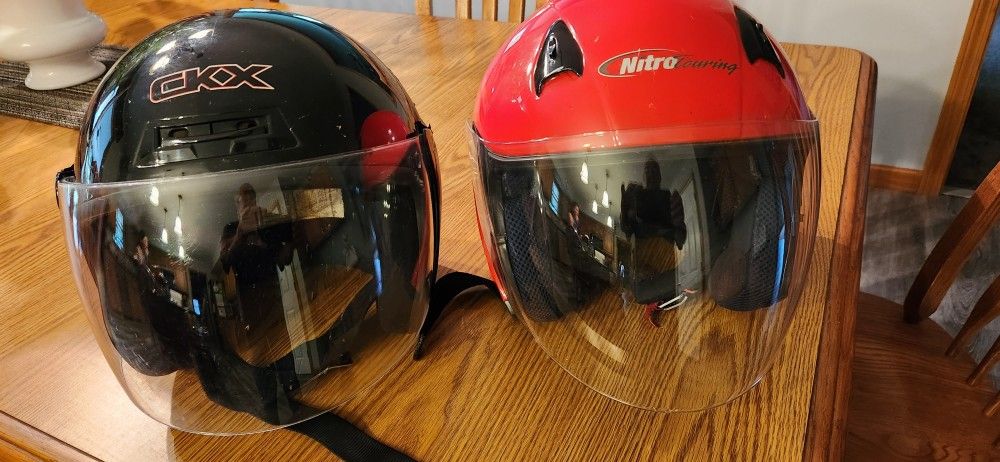 2 motorcycle helmets... Block one is $20... Red is $40...